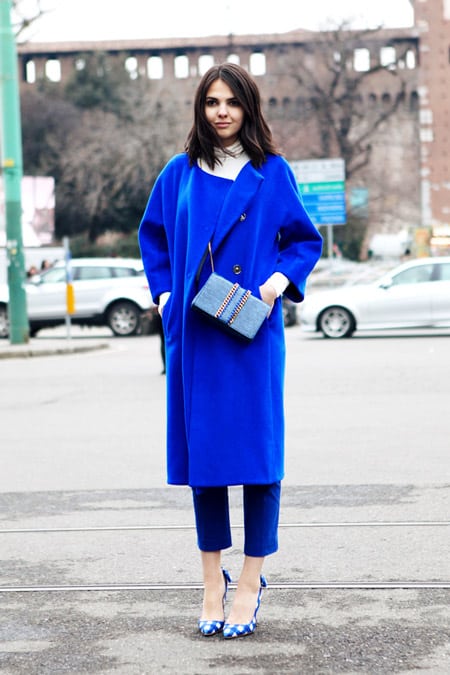 Девушка в укороченных синих брюках и синем пальто