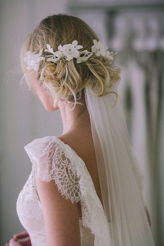 wedding hairstyles with veil curly messy blonde updo with white flower accessorie pahountis photography