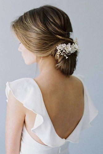 rustic wedding hairstyles low loose chignon wecorated with white flowers betsyblue via instagram