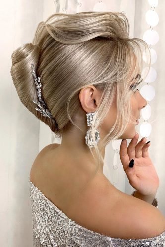 wedding updos smooth french roll on blonde hair with loose curls nadigerber